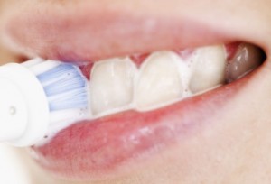 getty_rf_photo_of_woman_using_electric_toothbrush